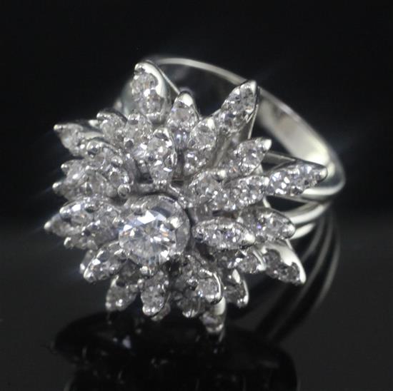 A 14ct white gold and diamond snowflake cluster dress ring, size M.